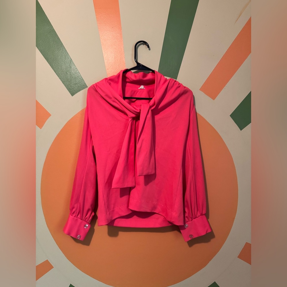 1970s bright pink blouse with tie neck and one small butterfly patch